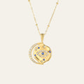 Gold necklace with an eye-shaped pendant on a beige background. This is Mettle & Bloom's signature style.